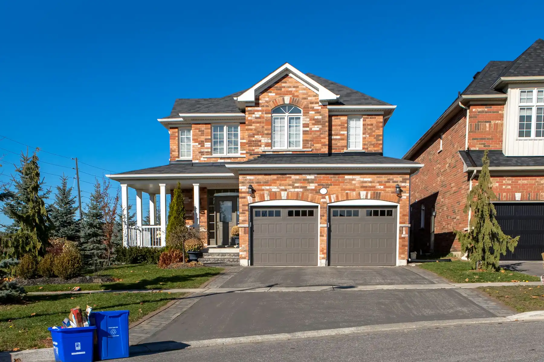 Row of brick two-storey houses on a suburban street in Ontario