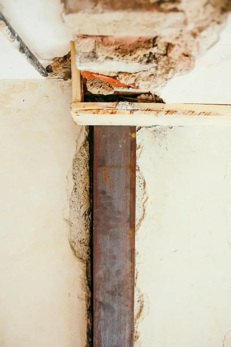 Brown staining and a gap where the wall meets the ceiling or floor