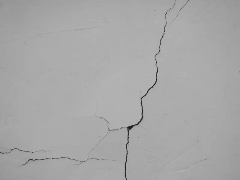 Diagonal crack running across a poured concrete basement wall
